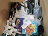 a cardboard box filled with various items that include toilet paper and other items