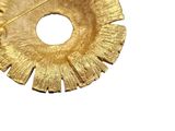 a close up of a gold brooch on a white background