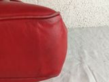 a red bag that is sitting on a white table