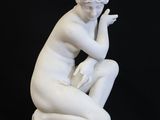 an image of a statue of a woman sitting on a black background