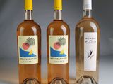 three bottles of wine sitting next to each other on a table