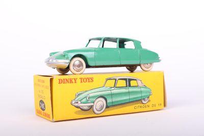 a green toy car sitting on top of a yellow box