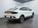 the rear end of a white suv parked in a garage