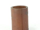 a small wooden cup that is sitting on a table