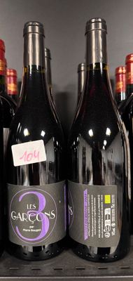 many bottles of wine on a shelf in a store