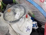 une pile de bagages dans un sac en plastique posée par terre