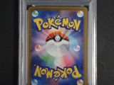 a close up of a pokemon card on a black surface