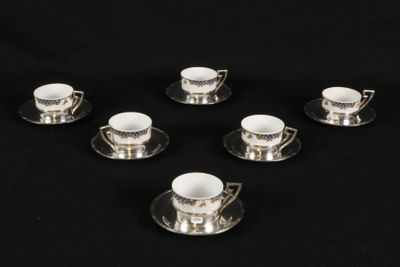 six cups and saucers are arranged in a circle on a black surface
