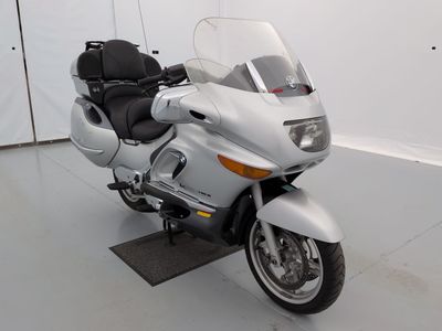 a white motorcycle parked in a room with white walls