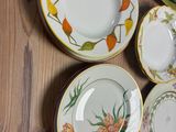 many plates and bowls on a table with a knife