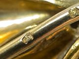 a close up view of a saxophone with a gold finish