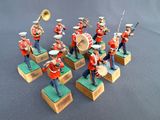 seven figurines of a marching band with a trumpet