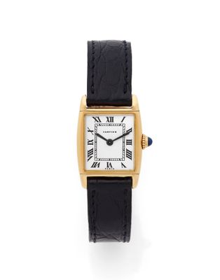 an 18k yellow gold cartier watch with black leather strap