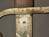 a close up of a knife with a wooden handle