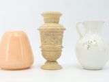 three vases sitting next to each other on a white surface