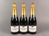 trois bouteilles de champagne posées côte à côte sur une table