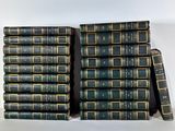 several books stacked on top of each other on a white surface