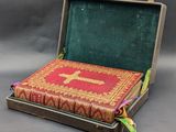 an open suitcase with a book inside of it