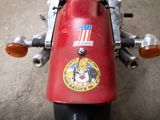 a red motorcycle with a sticker on the back of it