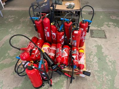 de nombreux extincteurs posés par terre dans le garage