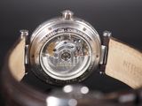 a close up of a watch with a leather band