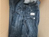 an open cardboard box with a pair of jeans inside of it