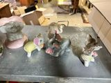 several figurines of elephants are sitting on a table in a room