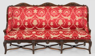 a red couch with a gold and red pattern on it
