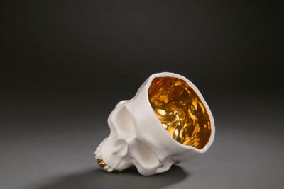 an image of a white and gold skull with a golden face
