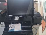 a black printer sitting on top of a desk next to a window