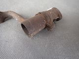 a rusted pipe on the floor of a car