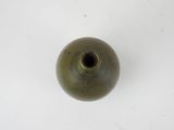 a green vase that is on a white surface