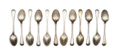 six silver spoons are lined up in a row on a white surface