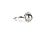 an image of a black pearl and diamond ring on a white background