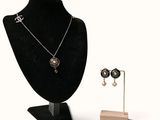 a necklace and earring set on display on a mannequin
