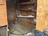 an image of a garage with a lot of junk on the floor