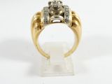 a close up of a gold ring with a diamond center