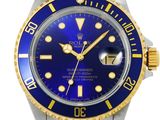 a close up of a watch with a blue face and yellow hands