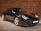 a picture of a black sports car parked in a garage