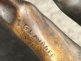 close up of a bronze statue of a man holding a baseball bat