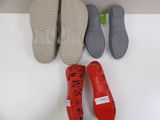 three pairs of red shoes are lined up next to each other