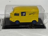a yellow toy truck in a clear case
