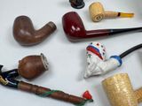 many different types of smoking pipes on the table