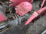 a pink motorcycle that is parked in a garage