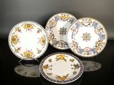 three plates and a bowl are sitting on a table