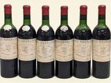 six bottles of wine are lined up in a row