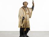 a statue of a man holding a sword and wearing a robe