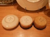 three cookies sitting on a table next to a plate