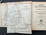 an old book with a map of paris on it and a pair of scissors on top of it
