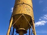 a yellow water tower with a blue sky in the background